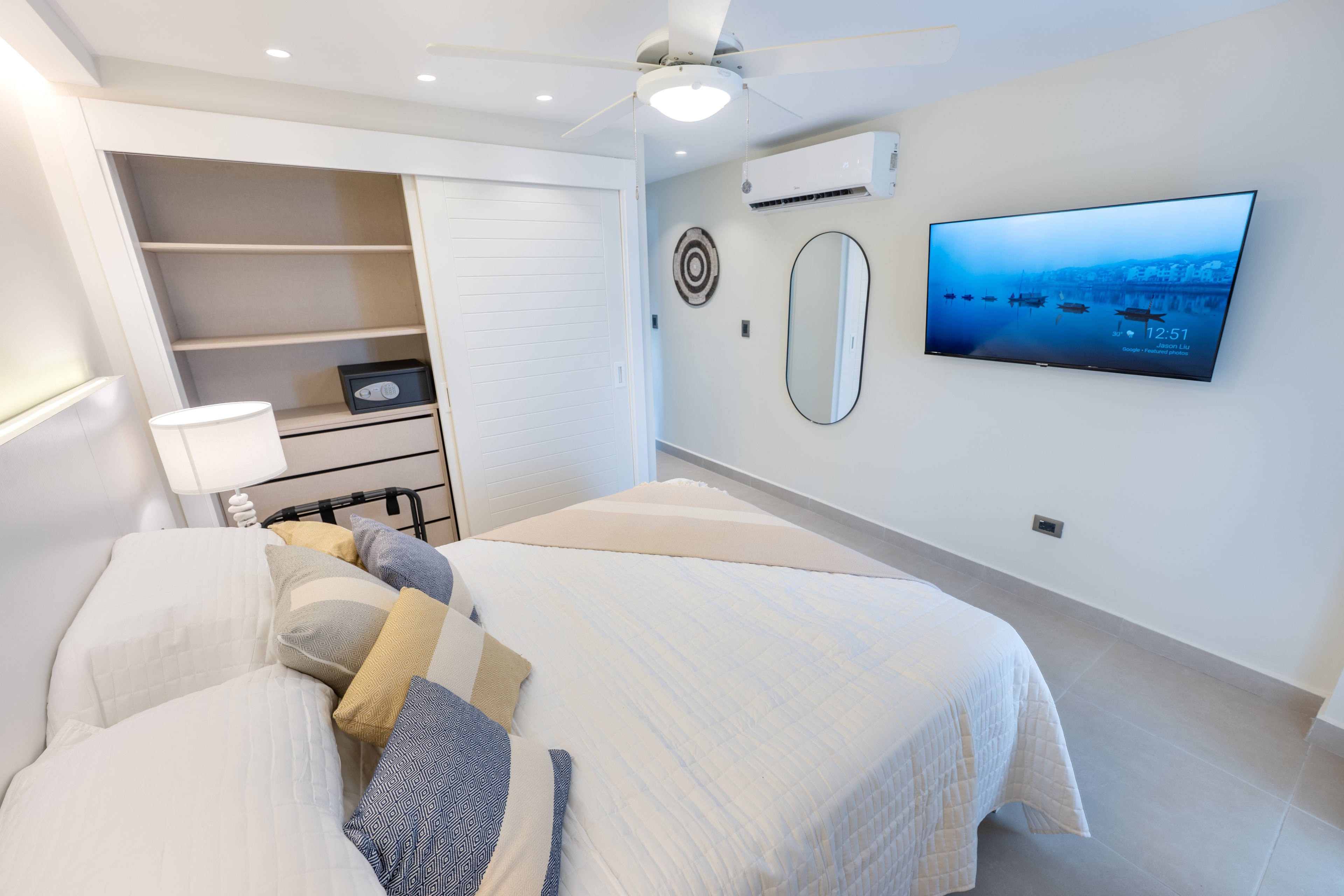 AlaNiqueStay Punta Cana penthouse — minimalist bedroom with wall-mounted TV