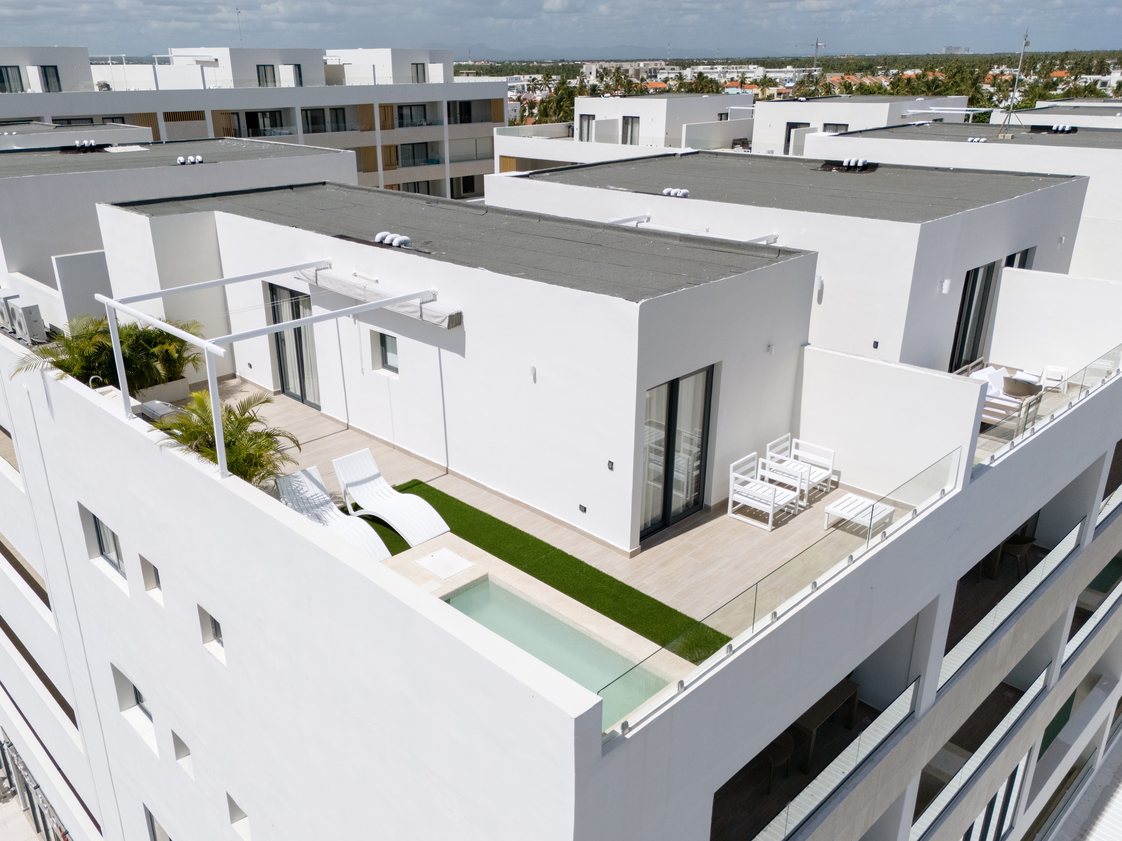 AlaNiqueStay rooftop terrace open-air lounge area with panoramic Punta Cana skyline views